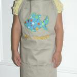 Harper Grace models the apron she will give to one of her preschool teachers on open house.